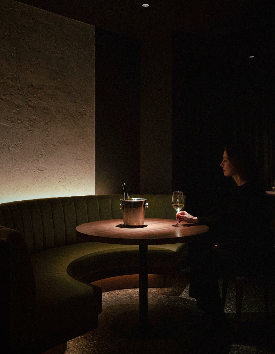 Guest alone in a velvet booth