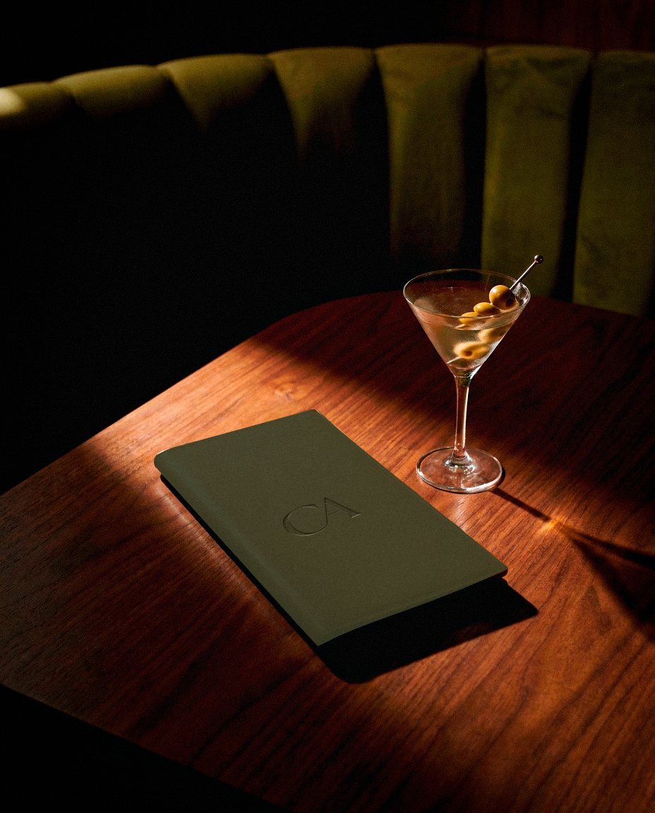 Check presenter and martini on a wooden table